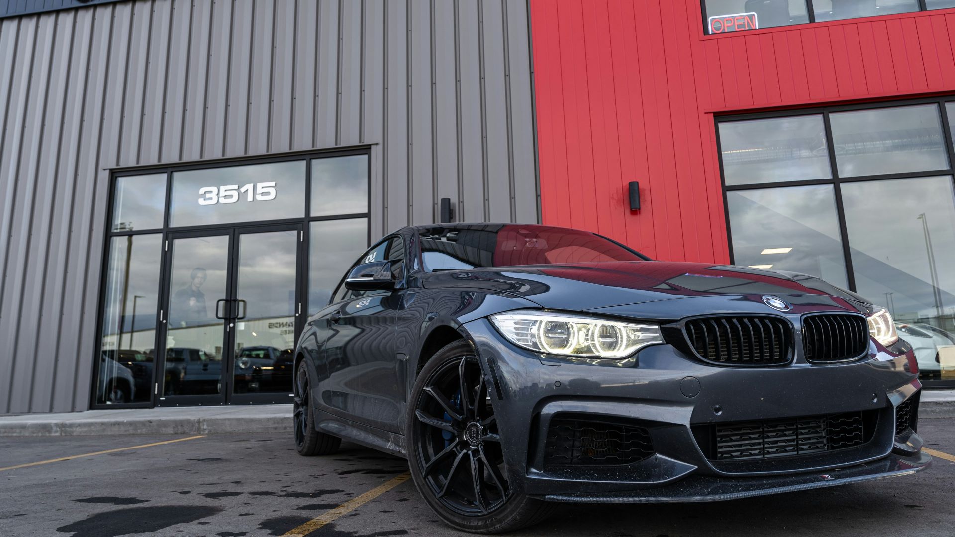 a black car parked in front of a building