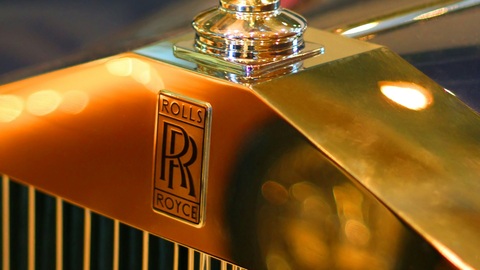 gold and black car hood ornament