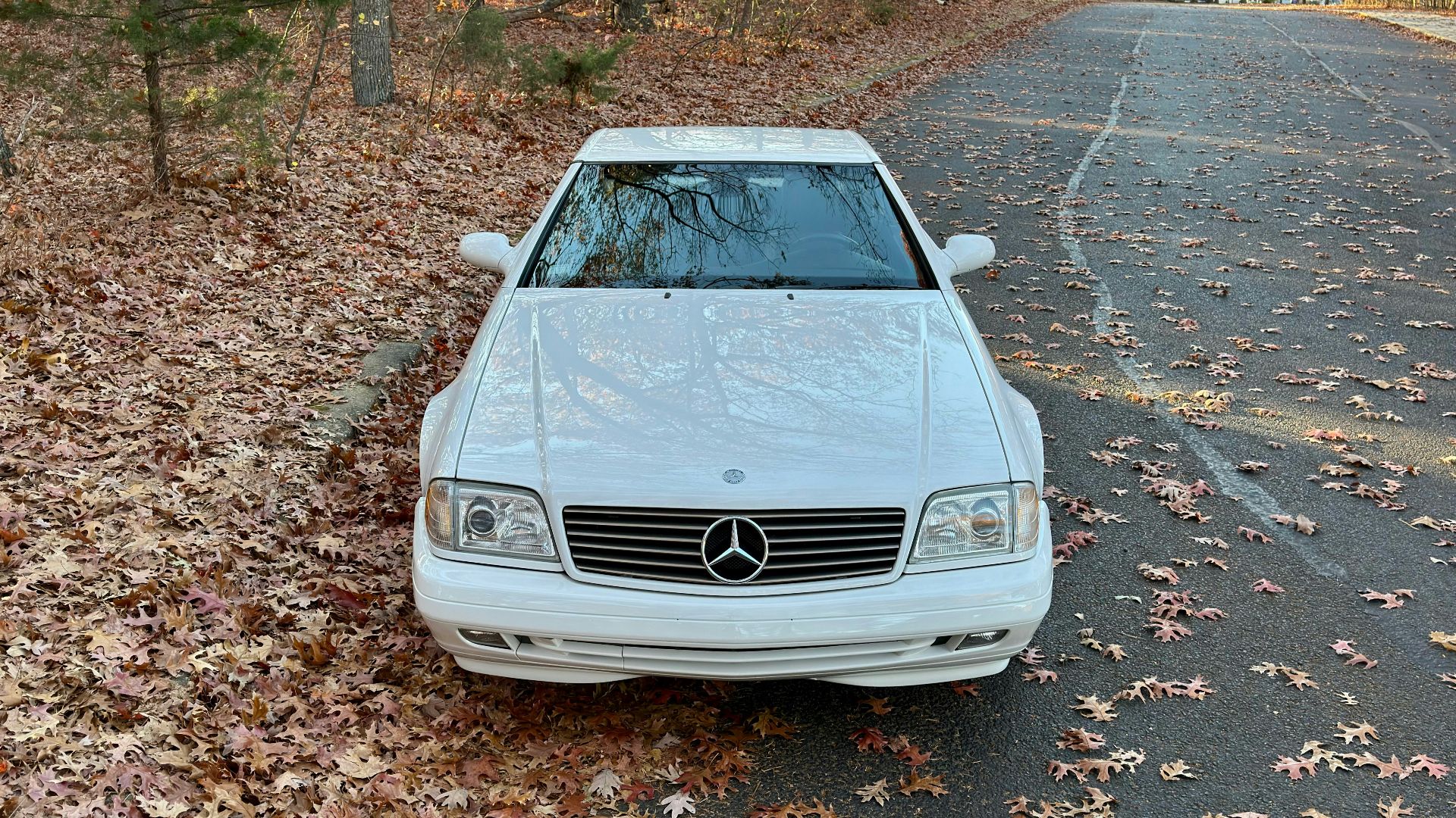 A white car parked on the side of a road