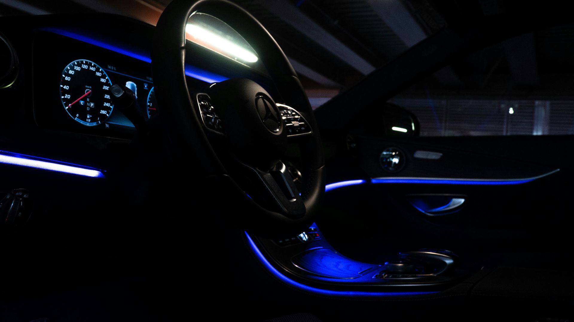 the interior of a car is lit up with blue lights