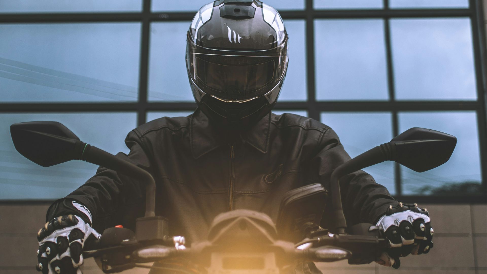 a person wearing a helmet and riding a motorcycle