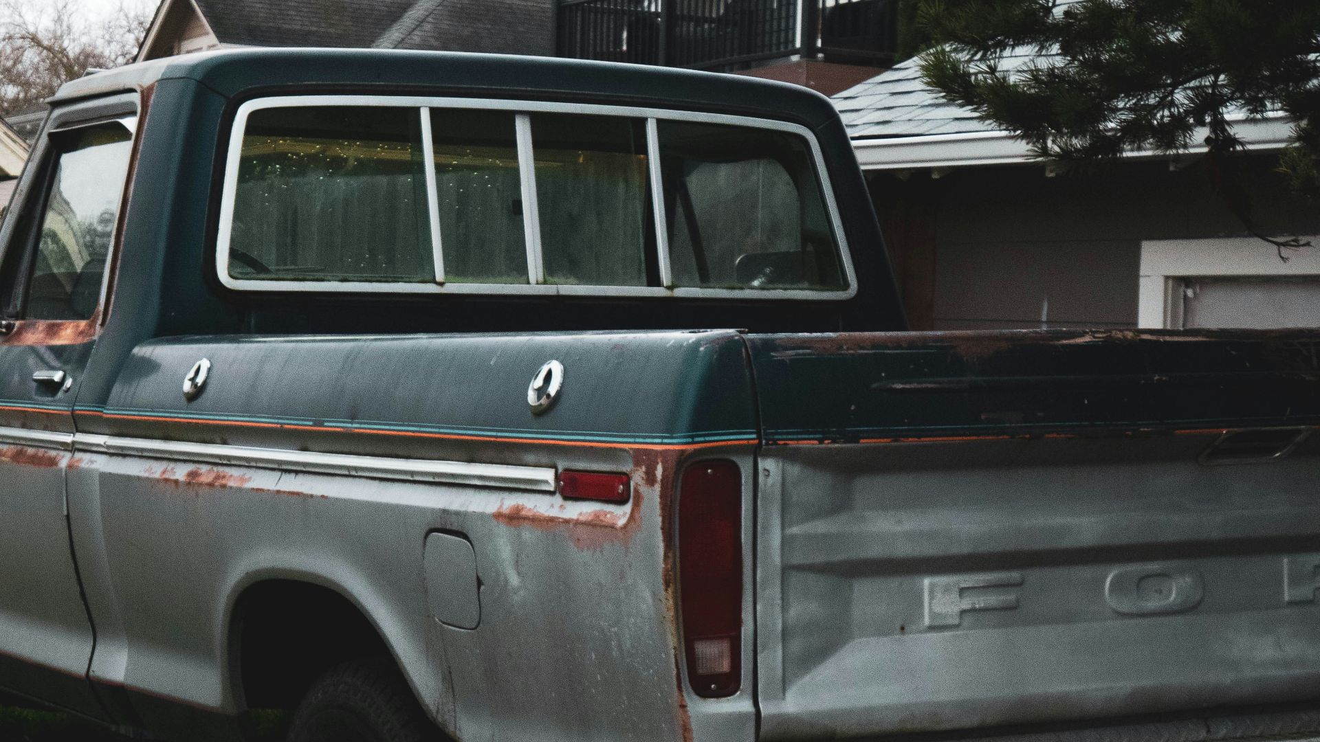 white and red chevrolet crew cab pickup truck parked on green grass field during daytime