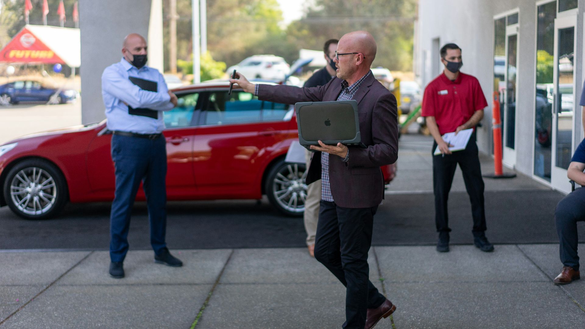 man in white dress shirt and black pants holding ipad