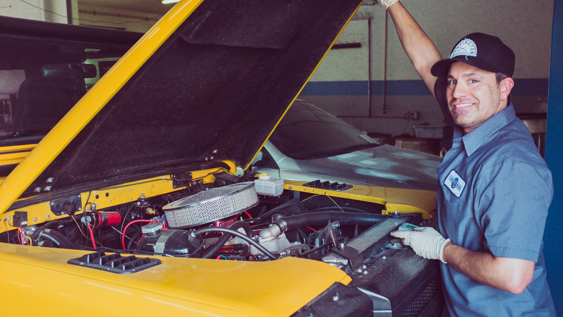 man holding open-wide car trunk