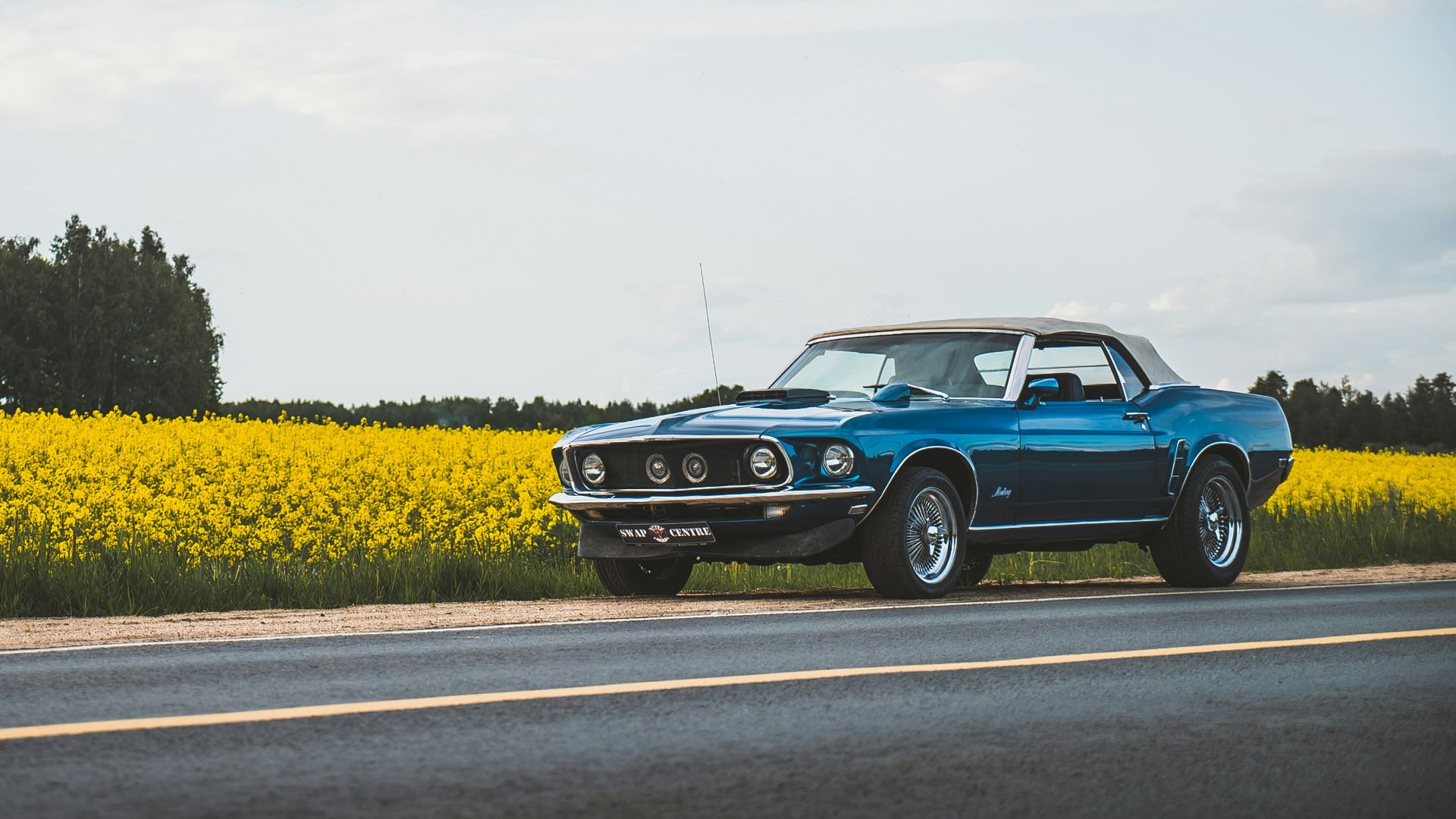 blue classic car on road during daytime