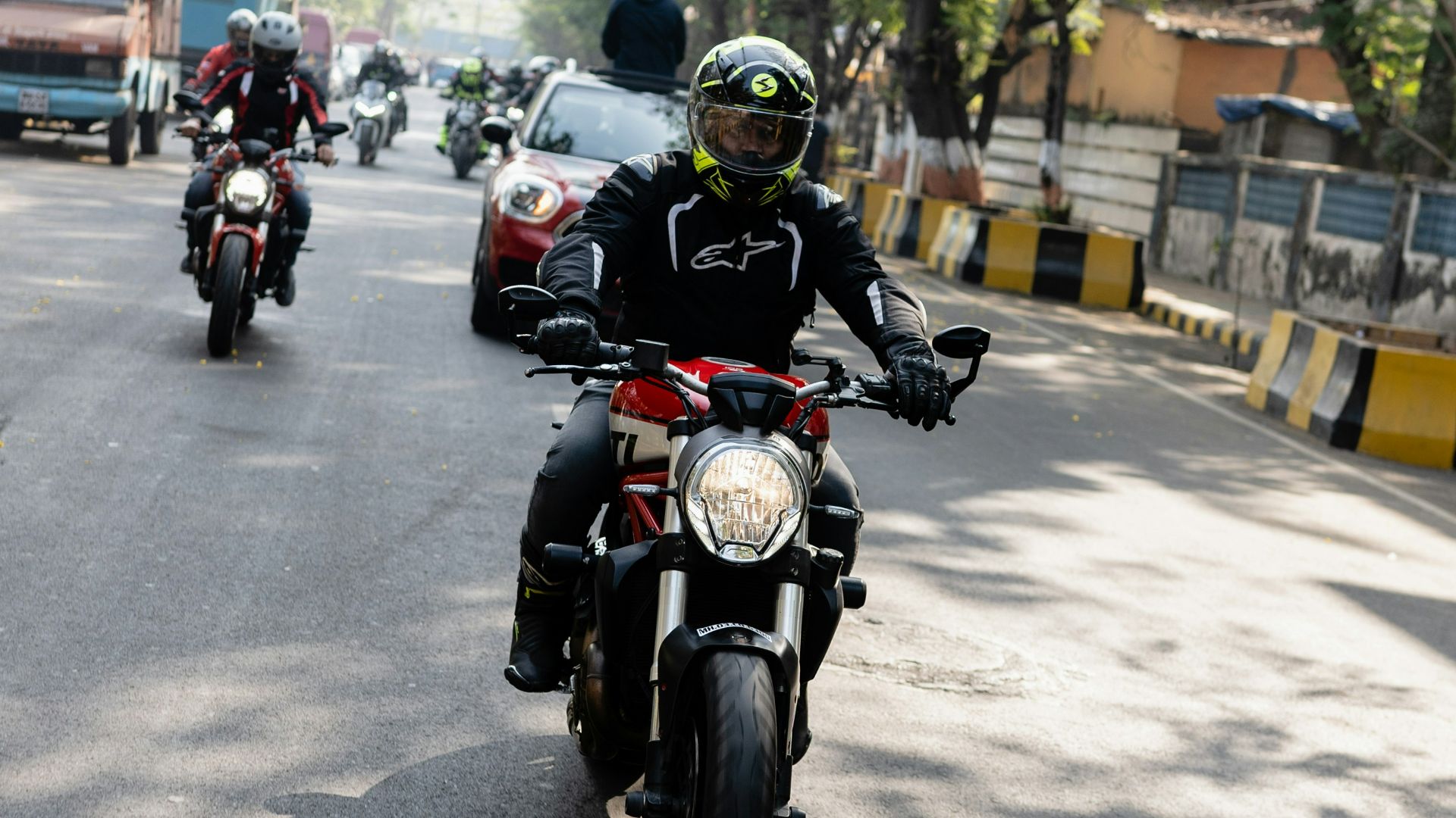 a group of people riding on the back of a motorcycle
