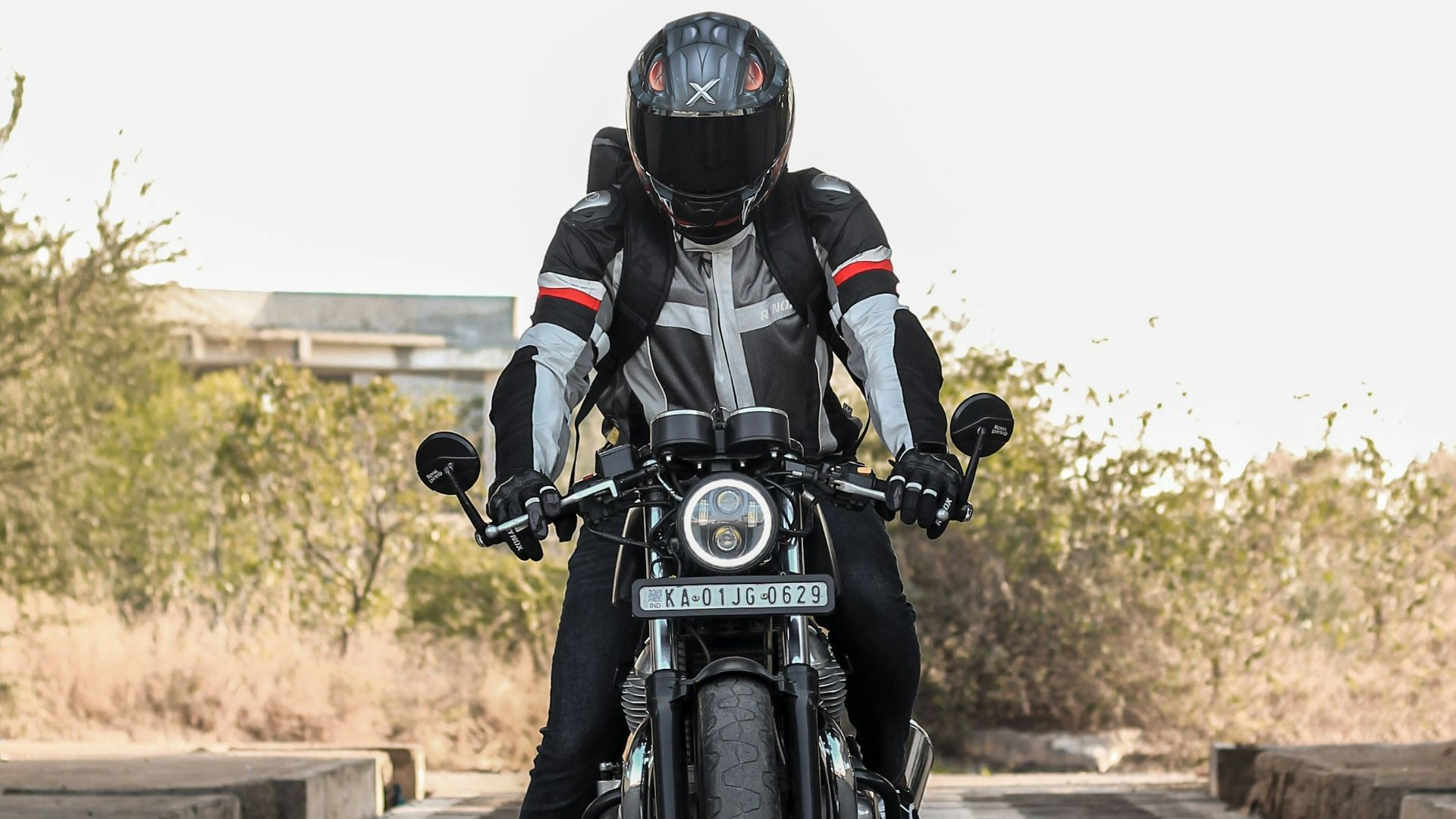 man in black helmet riding black motorcycle on road during daytime