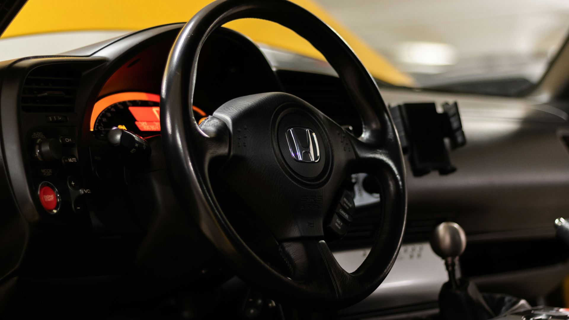 a close up of a steering wheel and dashboard of a car