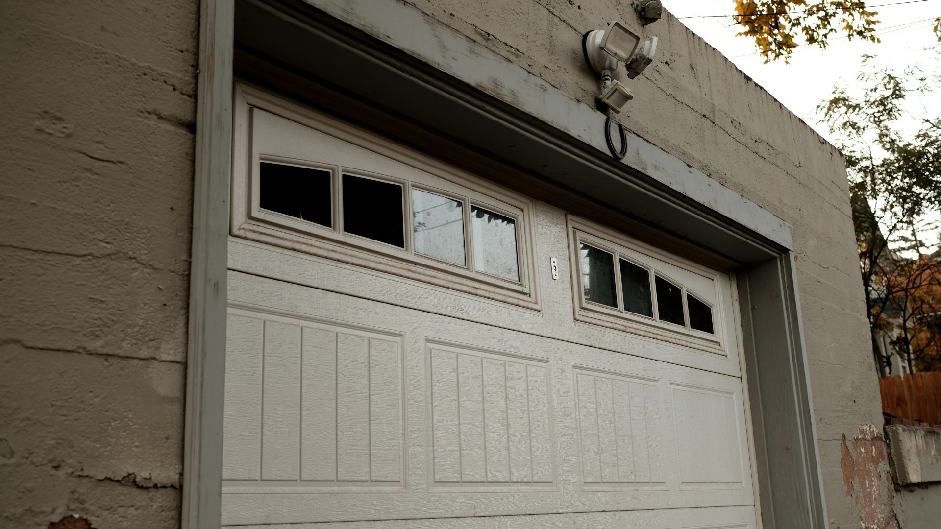 a white garage door on a brick building