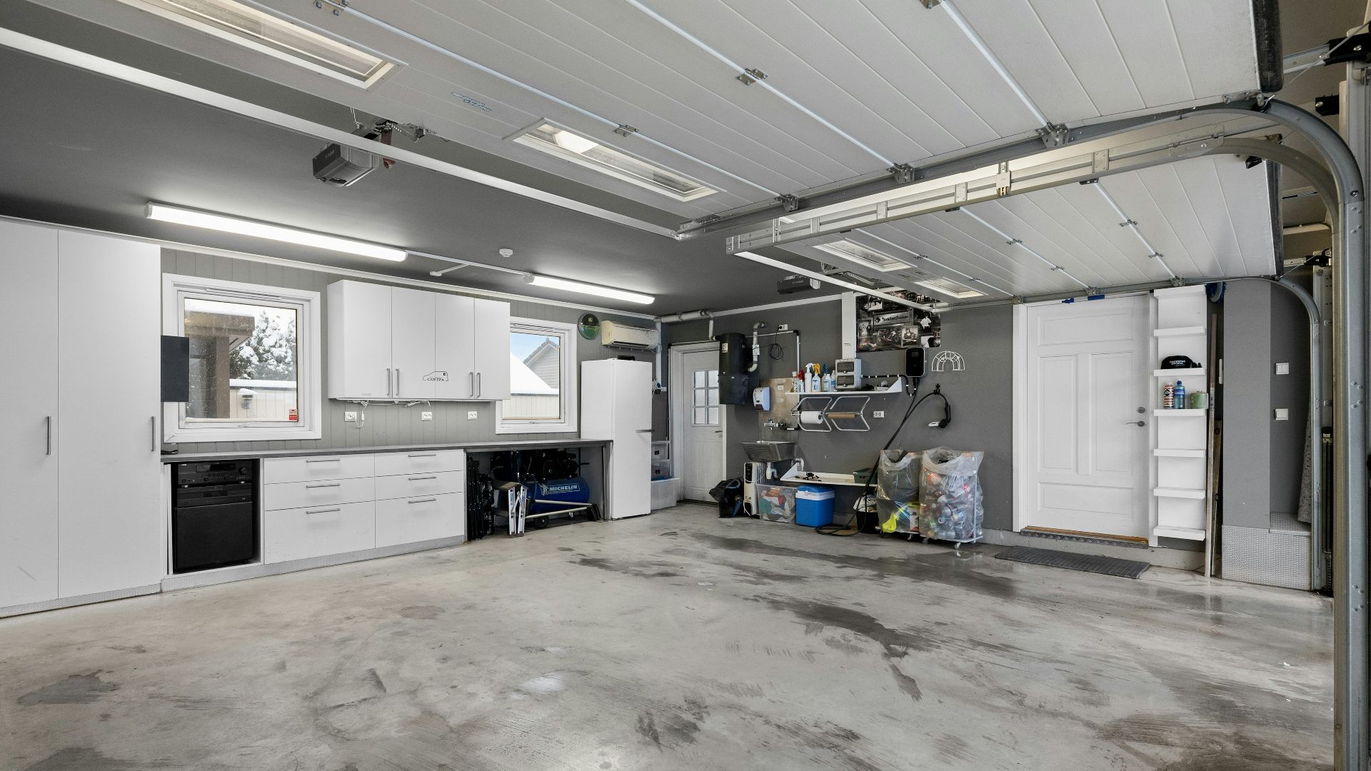 A large room with a lot of white cabinets
