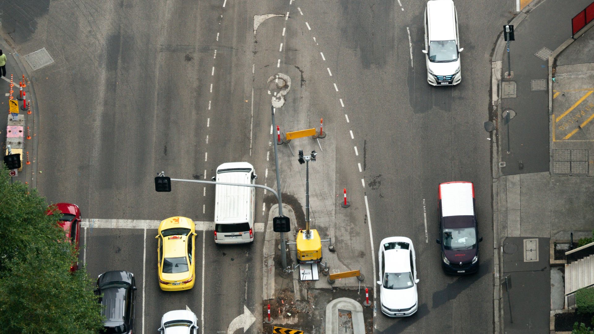 an overhead view of a street with cars and trucks