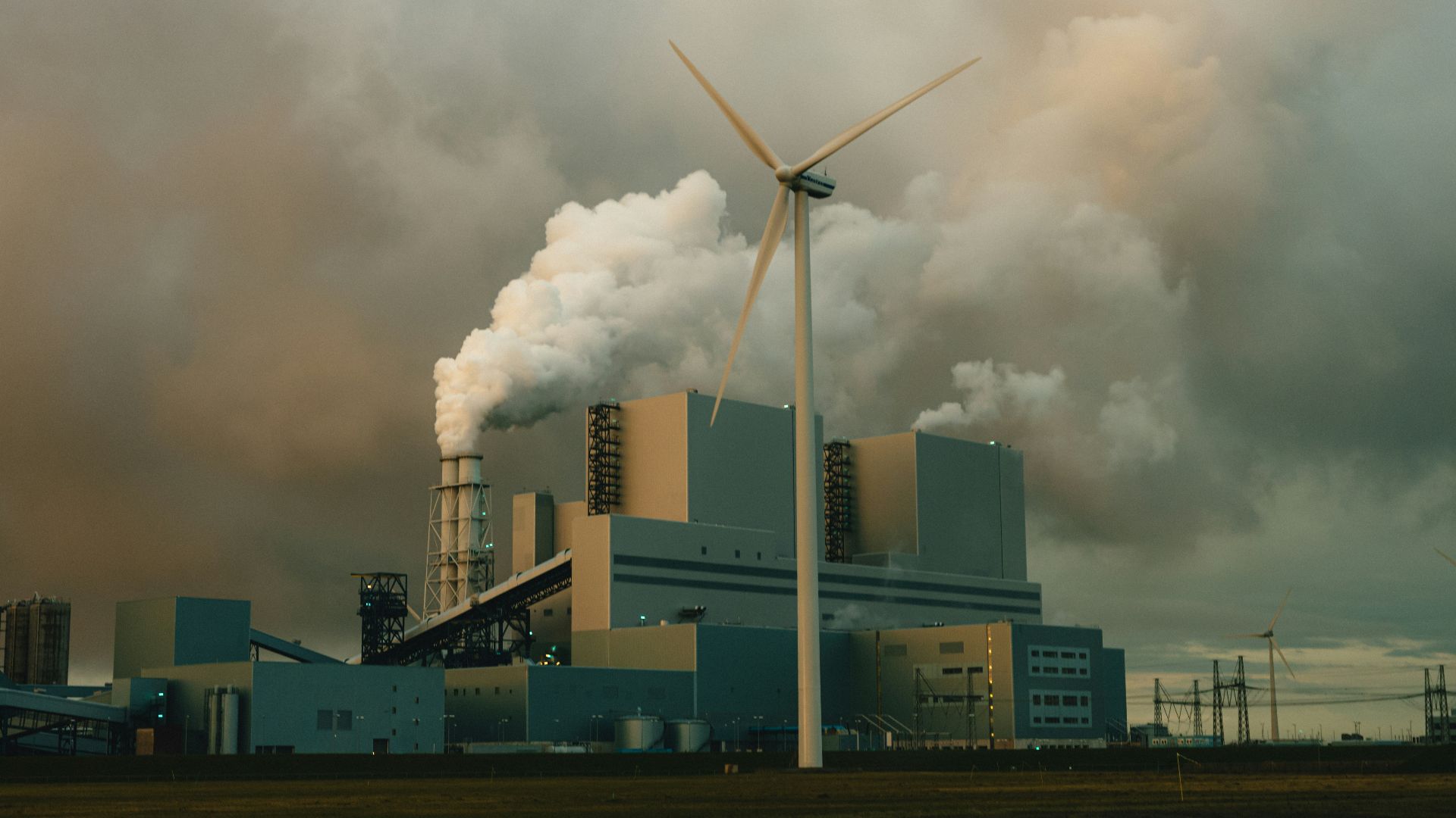 a factory with smoke billowing out of it's stacks