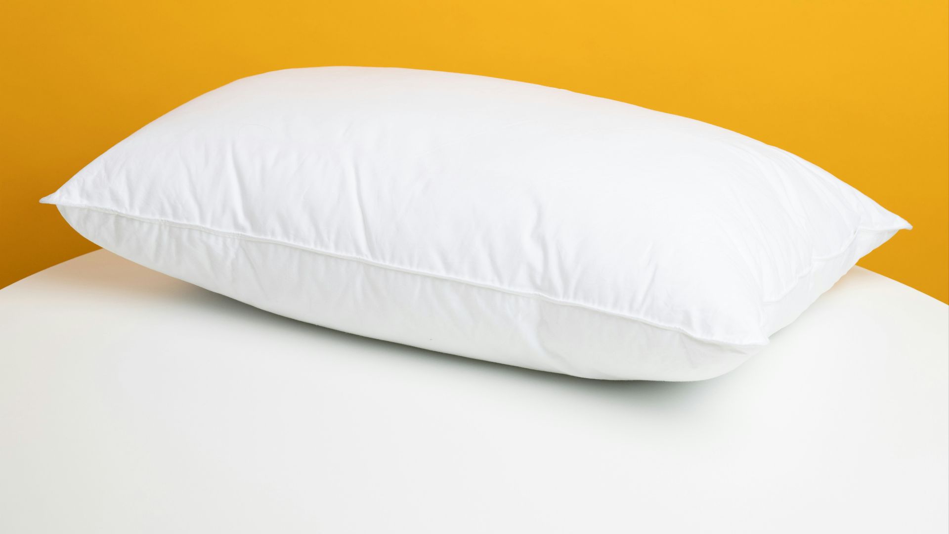 white pillow on white bed