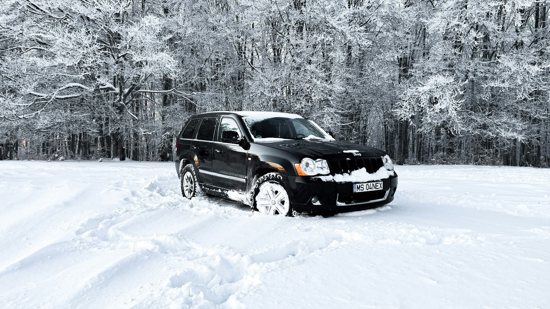 a black car is parked in the snow