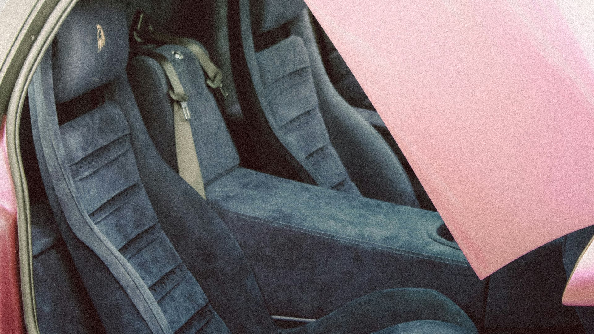 A pink car with the door open showing the interior