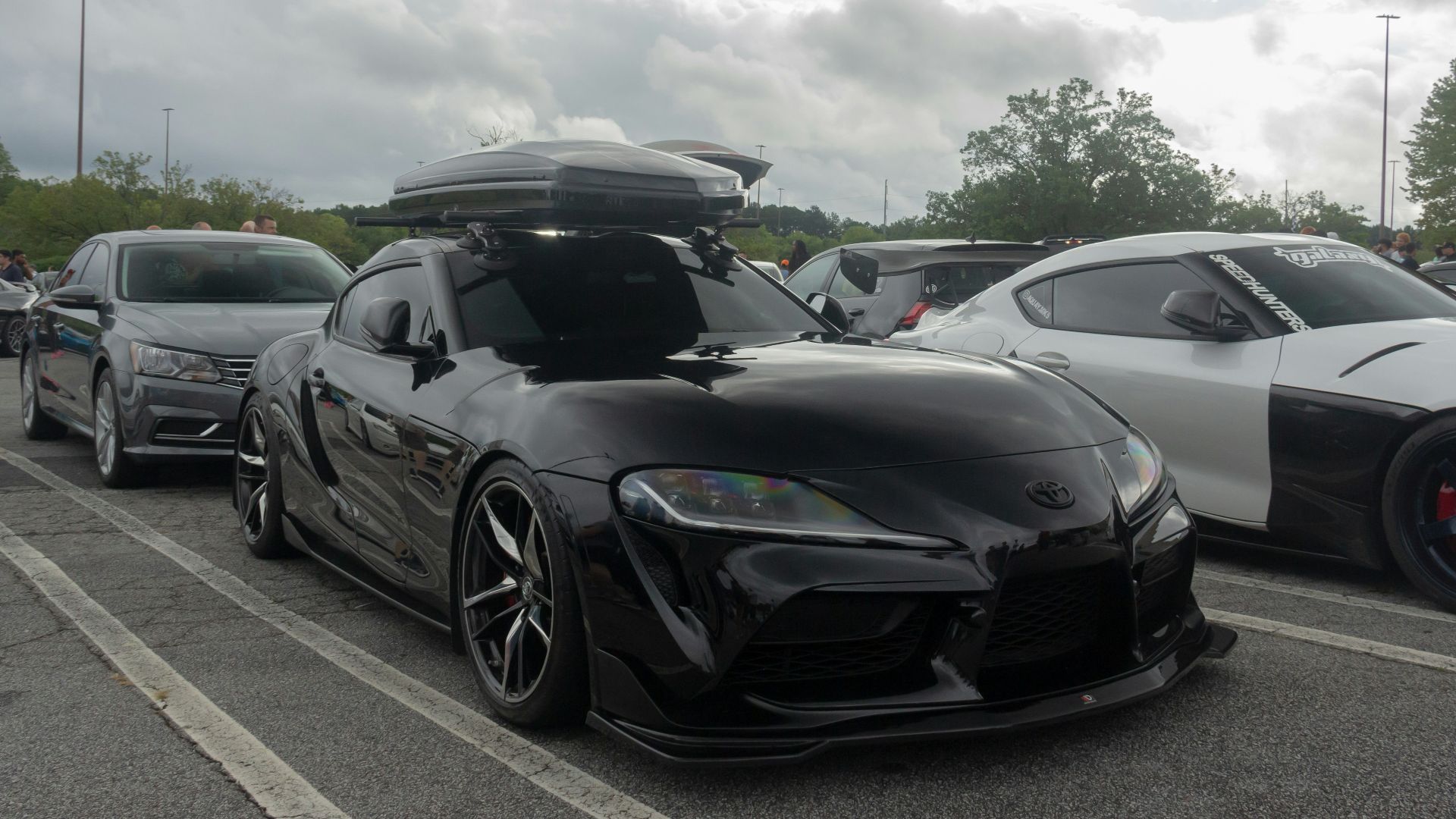 a group of cars parked next to each other in a parking lot