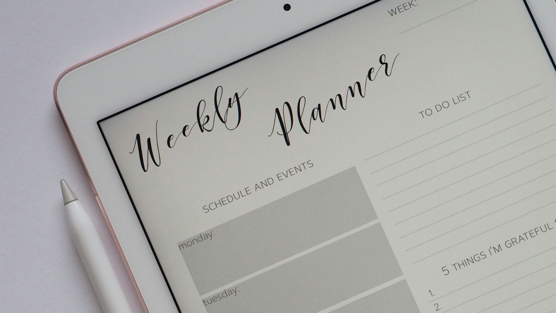 flat lay photography of turned-on silver iPad beside Apple Pencil