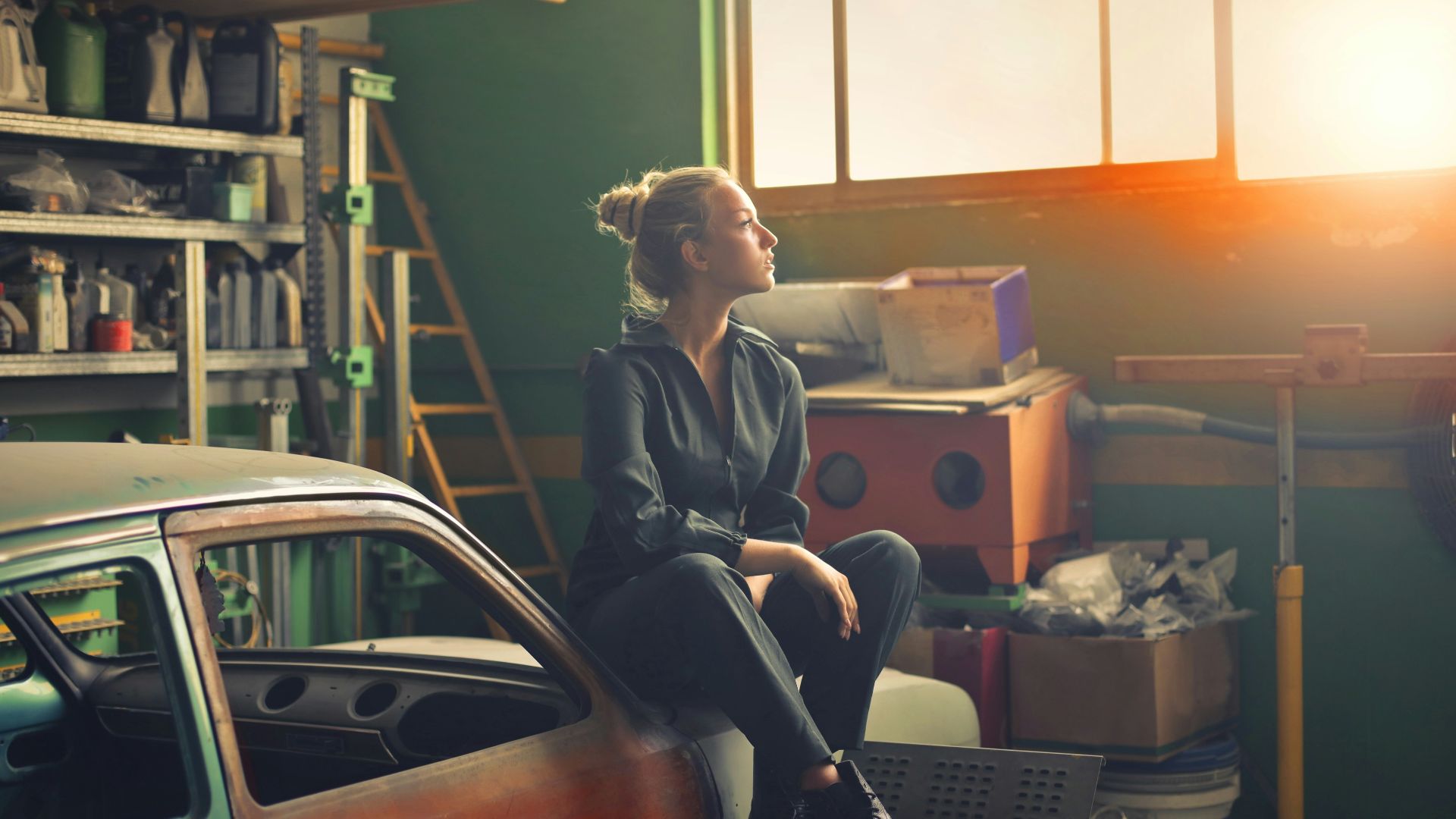 woman sitting on orange vehicle