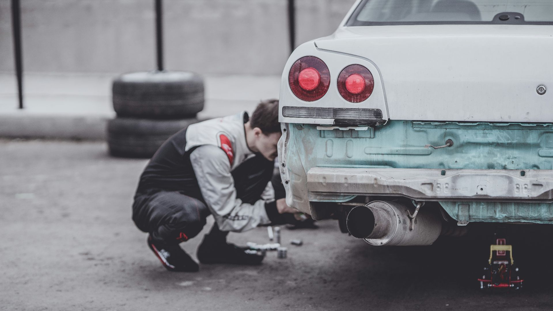 man fixing car