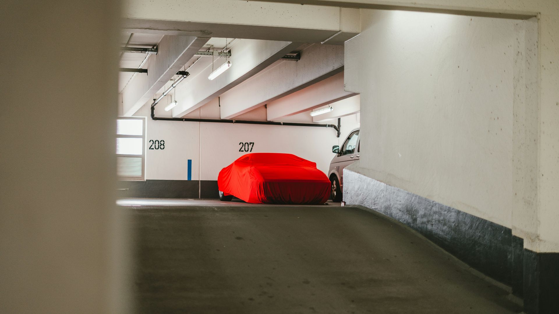 red car parked in garage