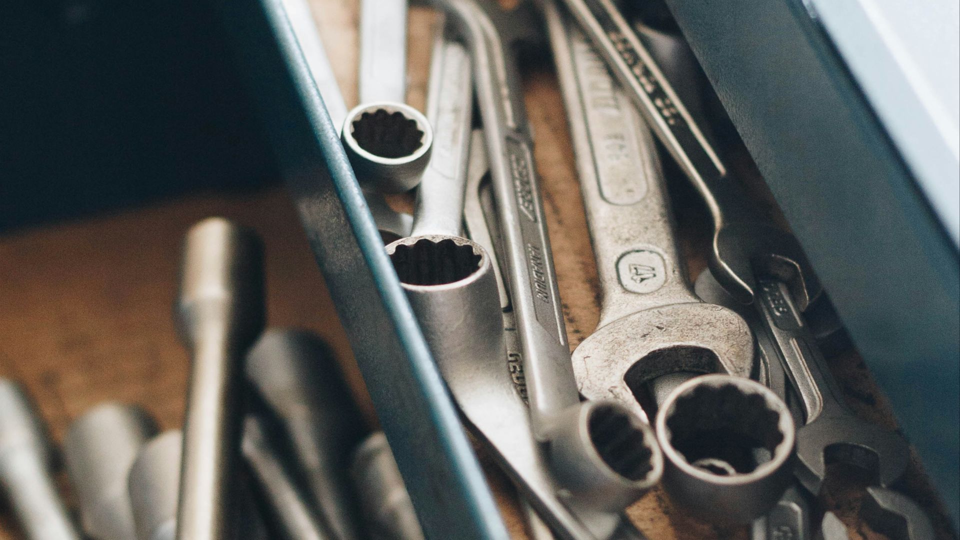 a bunch of wrenches and other tools in a box