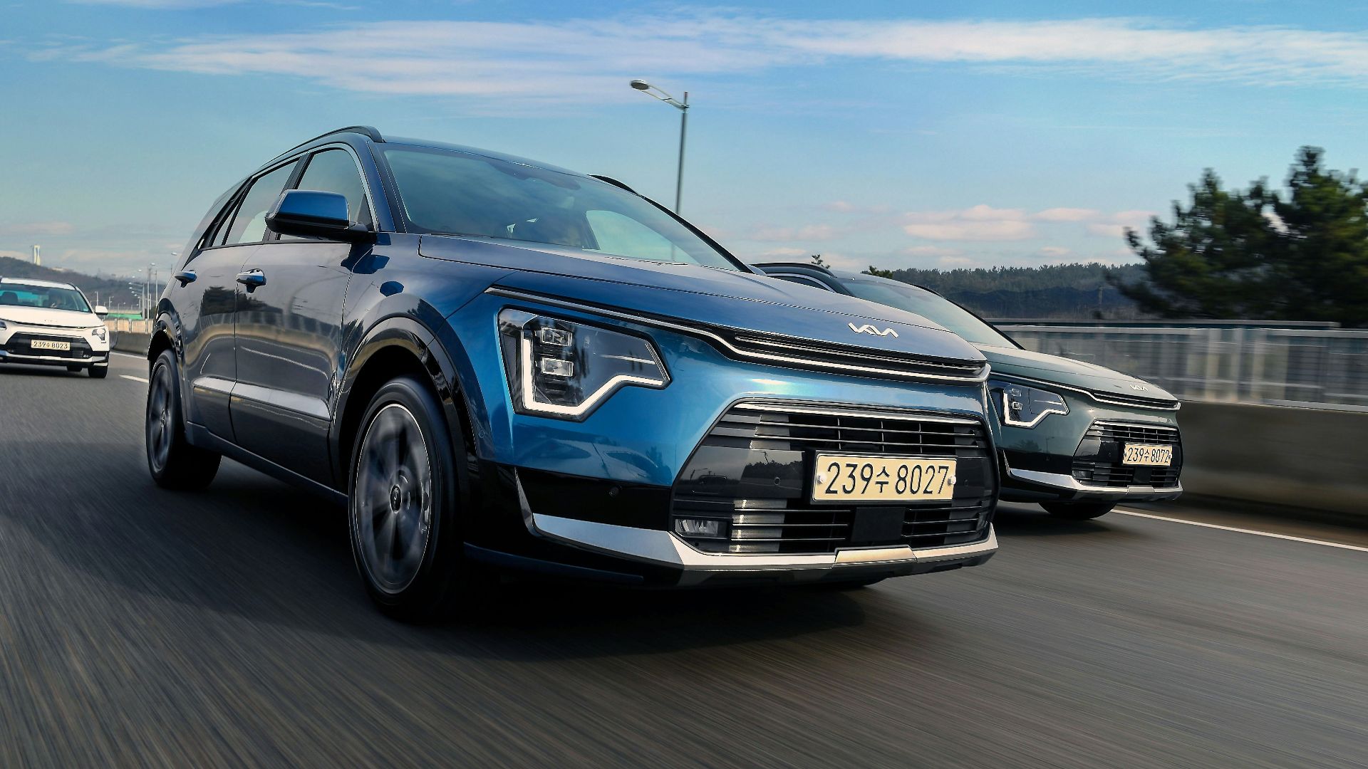 a couple of cars driving down a highway