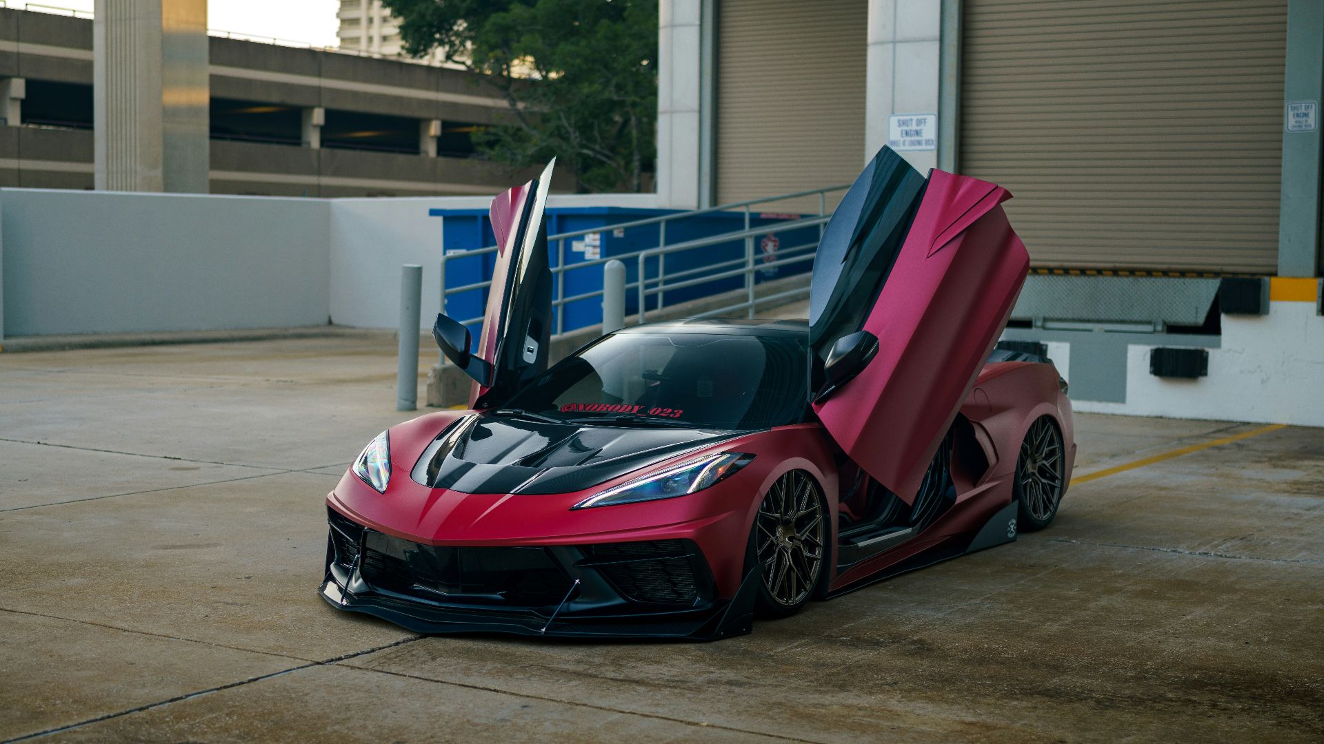 a red sports car parked in front of a building