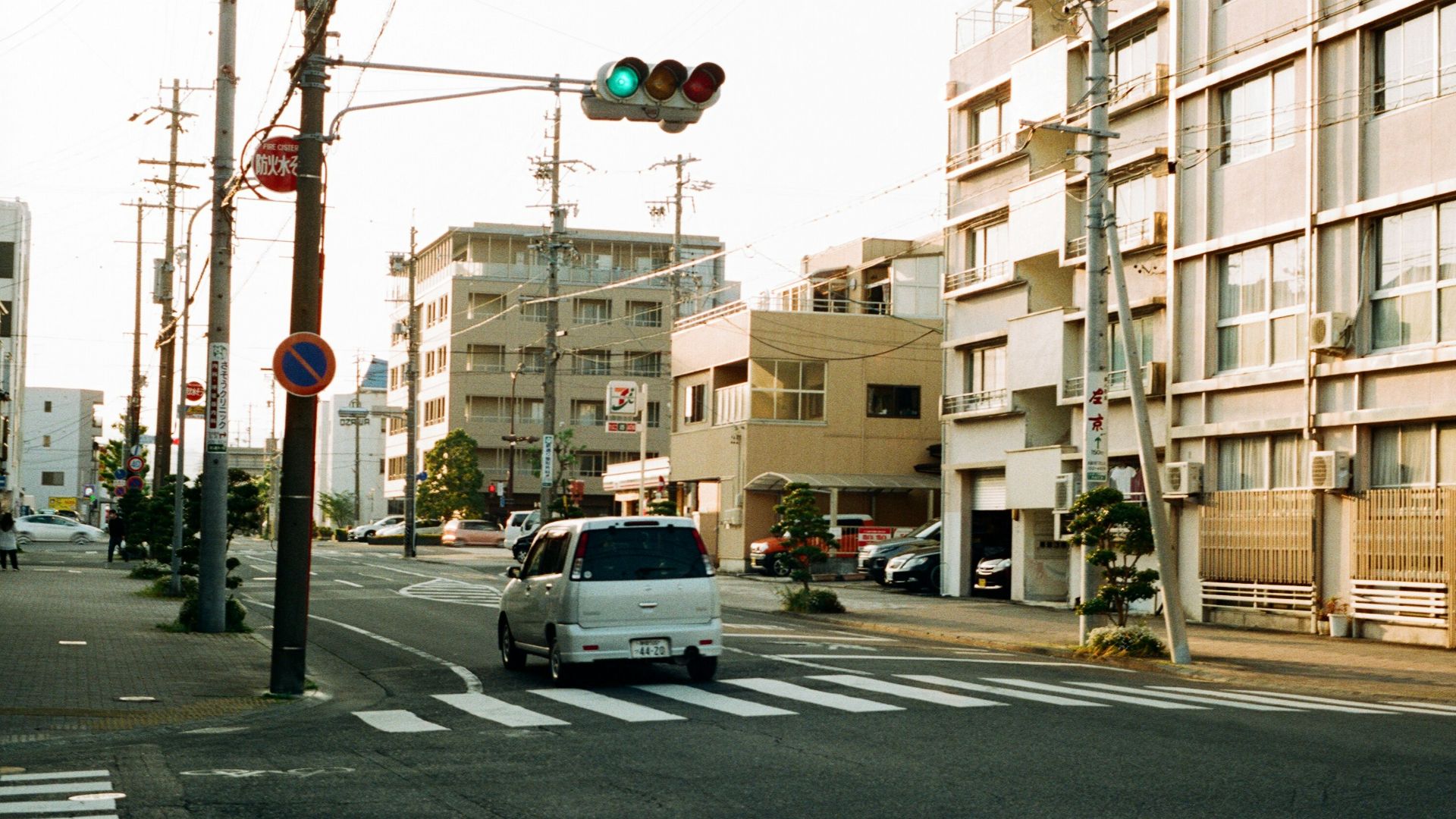 white car on road near traffic light during daytime