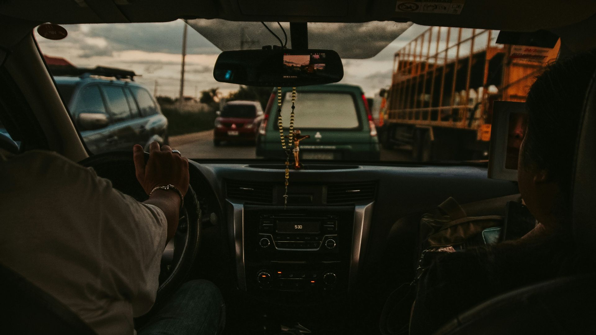 a man driving a car down a street