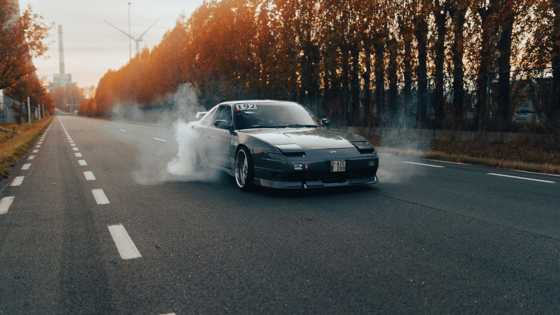 a car driving on a road with smoke coming out of it