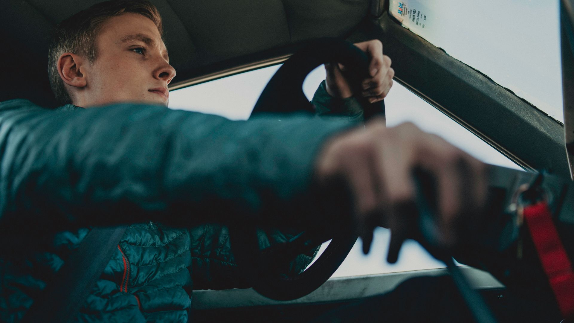 man wearing black jacket driving on vehicle