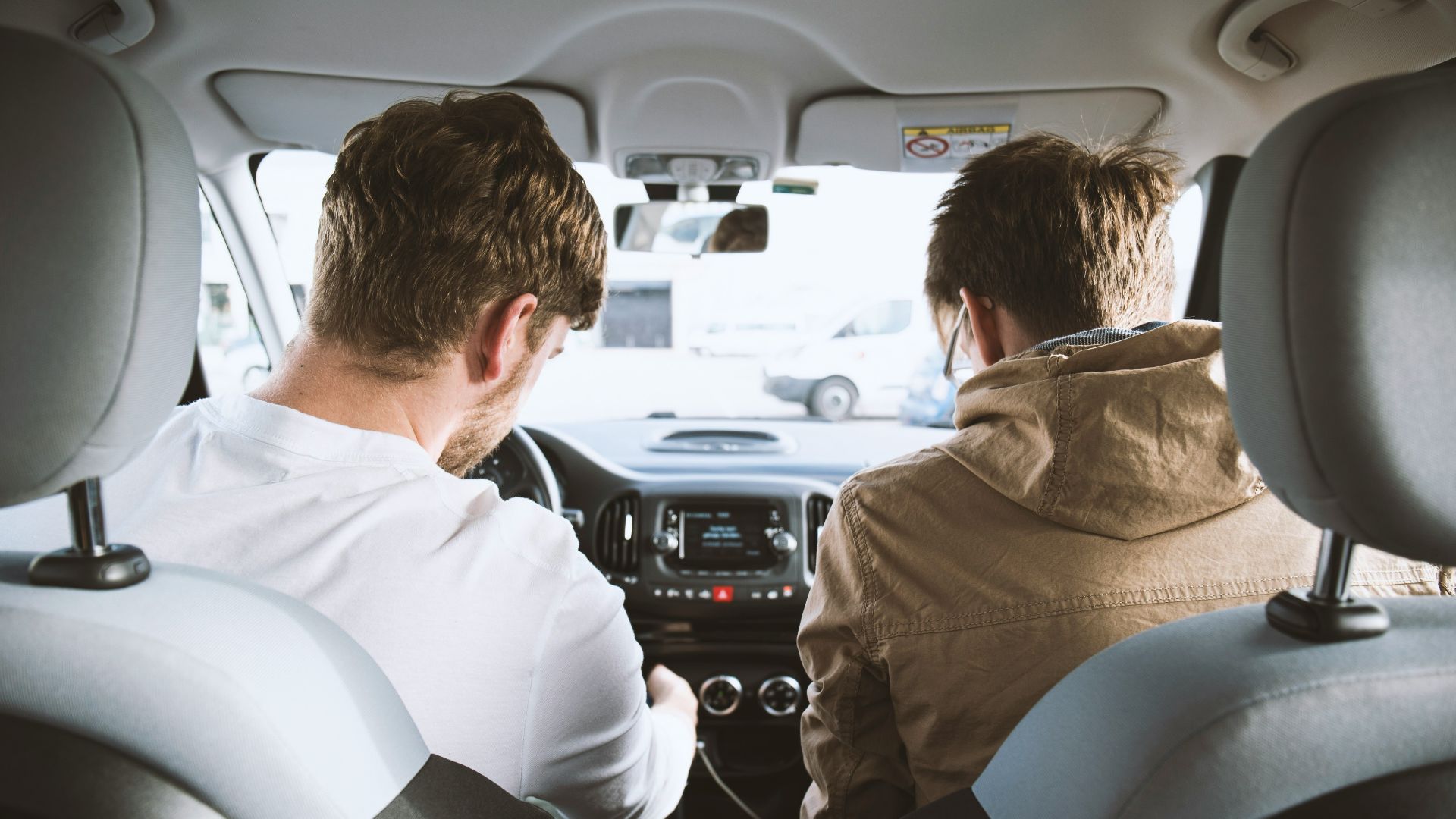 two men sitting inside vehicle