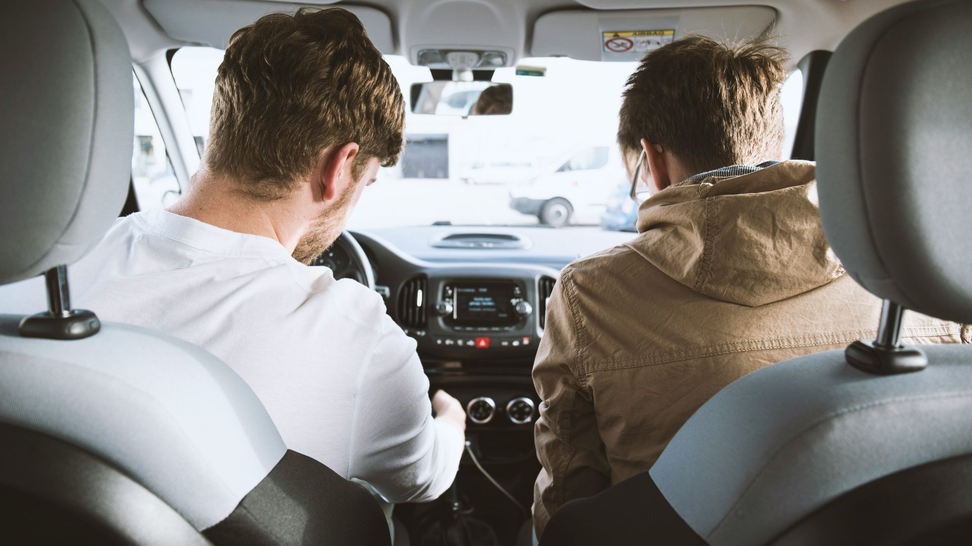 two men sitting inside vehicle
