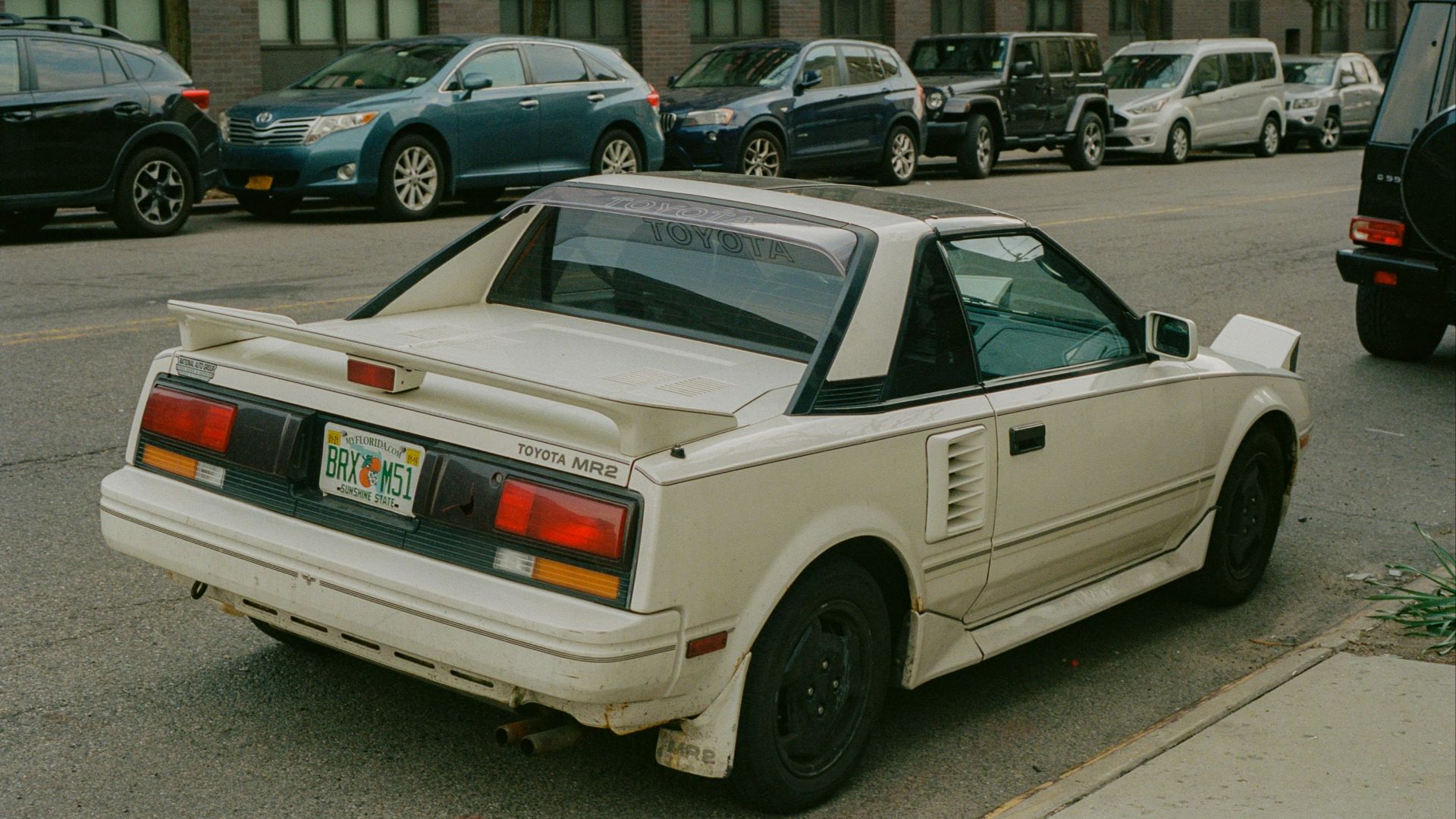 a white car parked on the side of the road