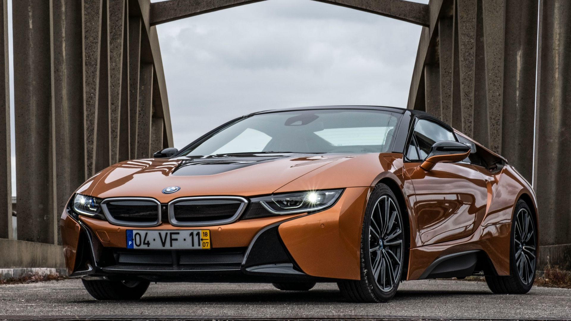 orange BMW coupe parking near road