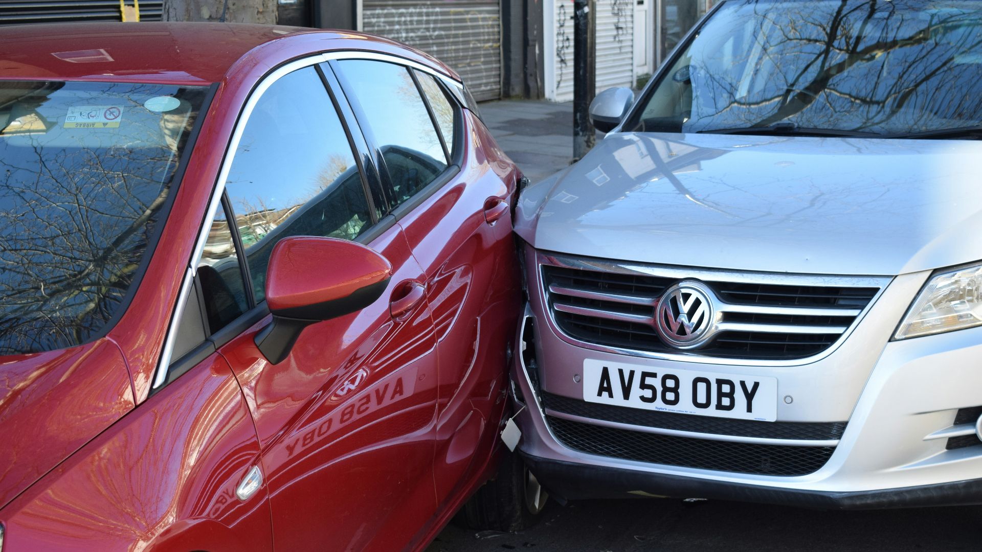 two cars parked next to each other in a parking lot