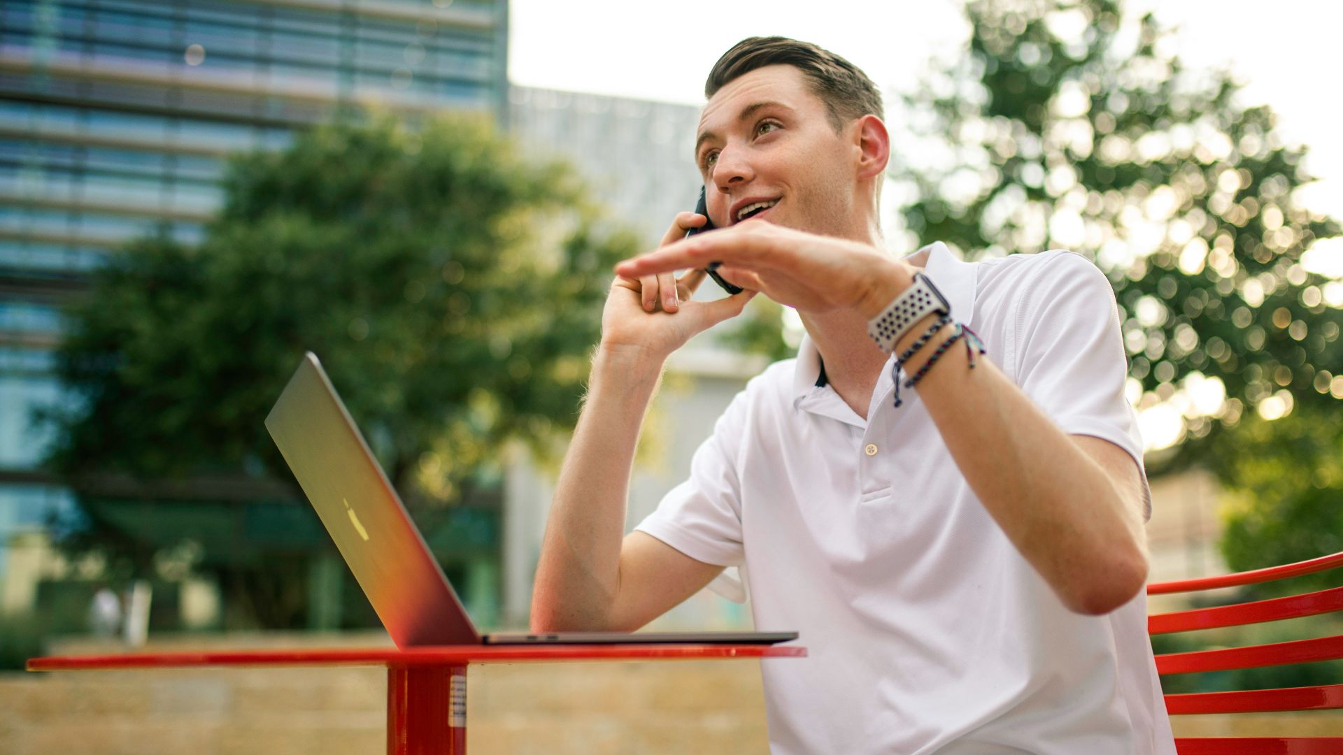man in white crew neck t-shirt holding gray laptop computer