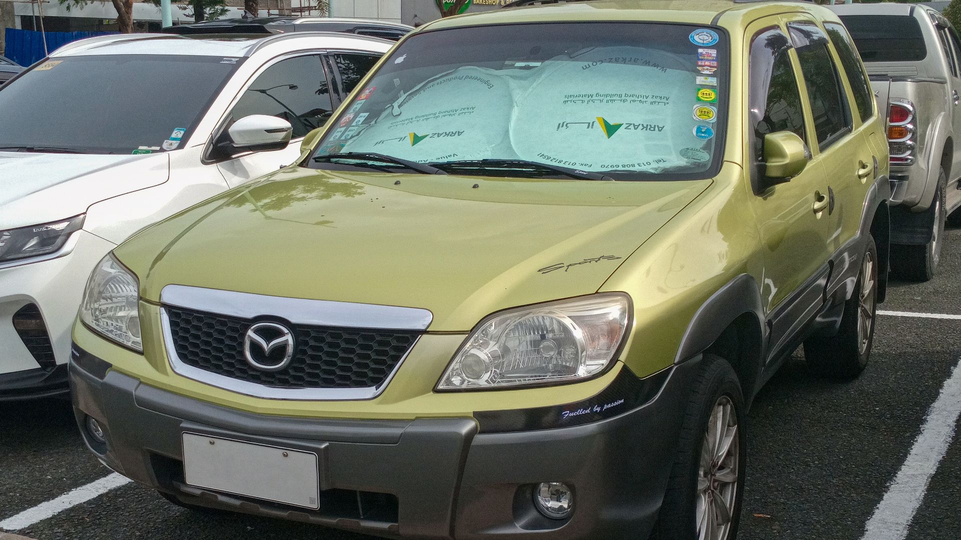 File:2007 Mazda Tribute 2.3L 2WD in Sublime 2-Tone, front left.jpg