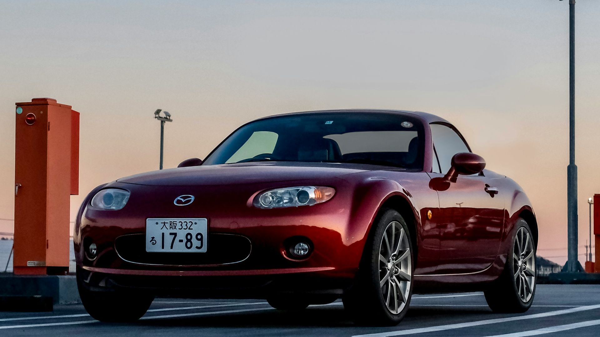 a red sports car parked in a parking lot