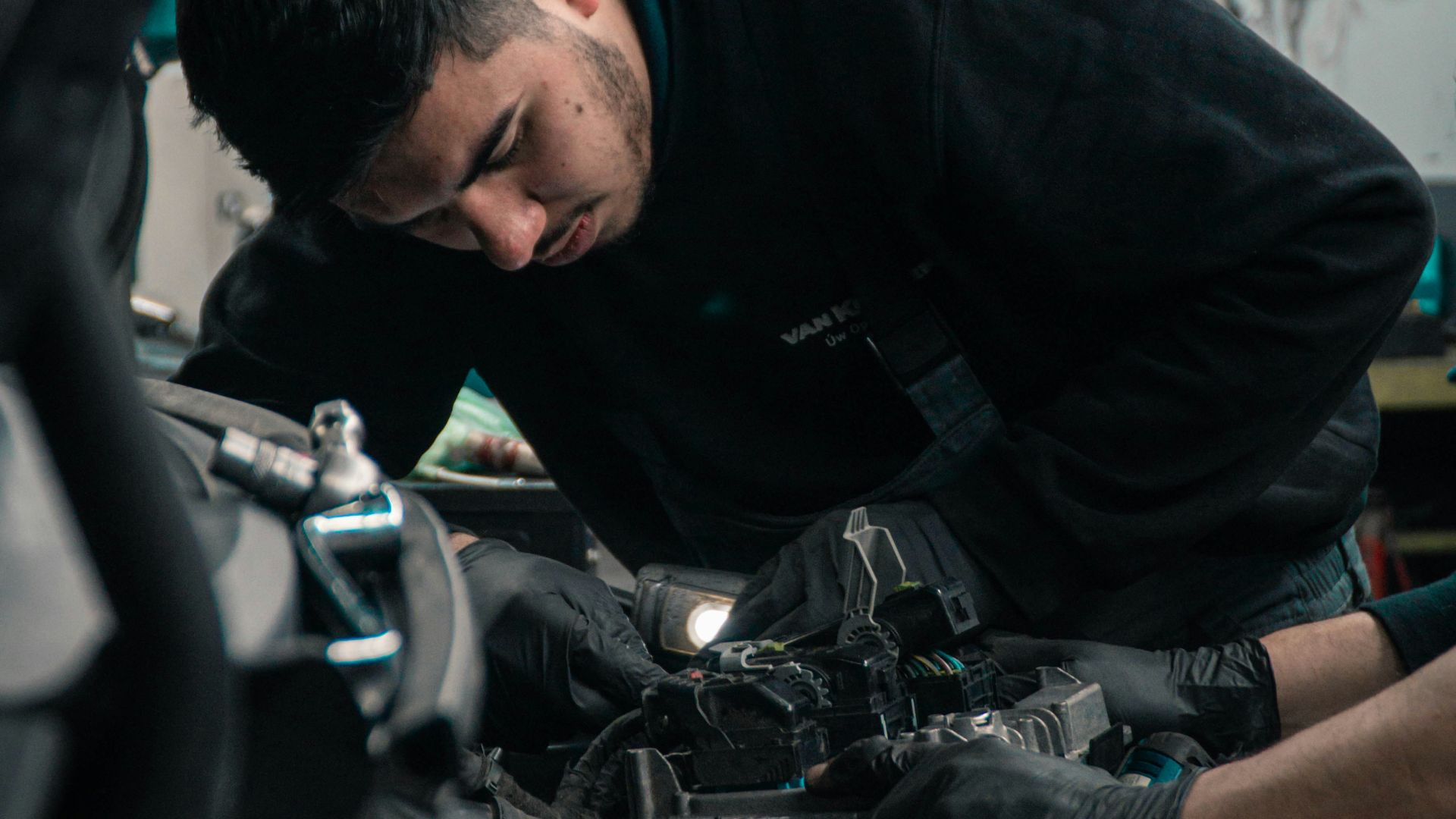 man in black jacket and blue denim jeans riding motorcycle