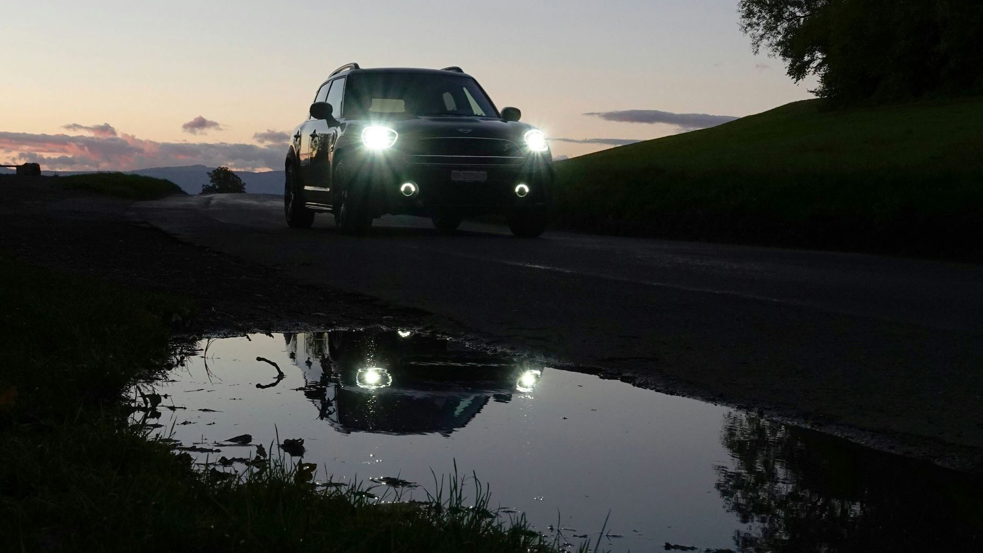 a car driving down a road at night