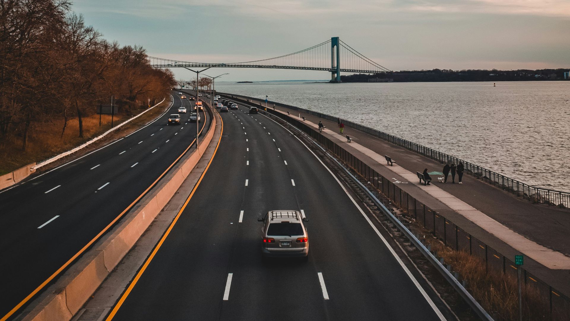 car on road near body of water