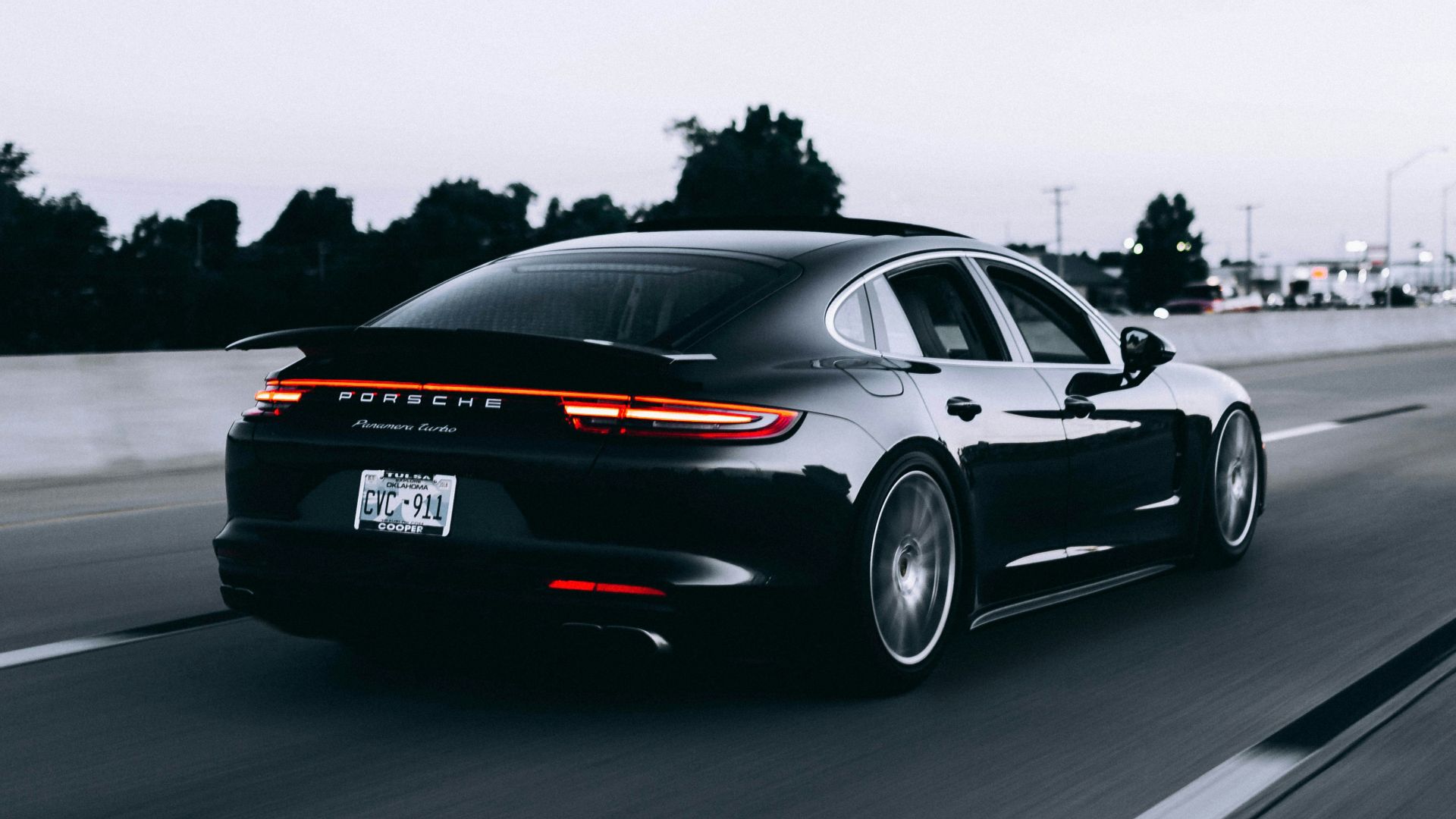 running black Porsche sedan