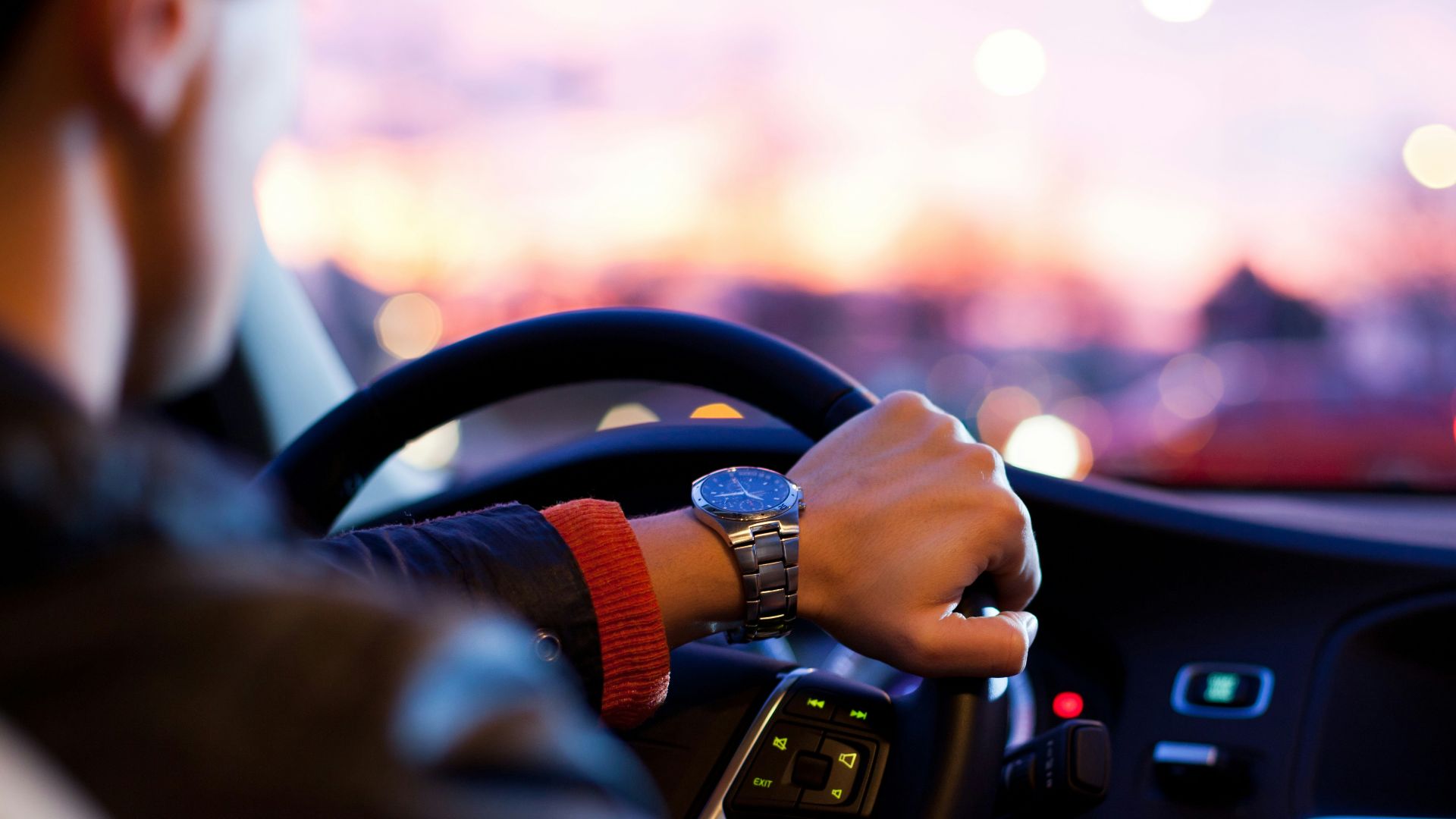 man driving a car wearing wrist watch