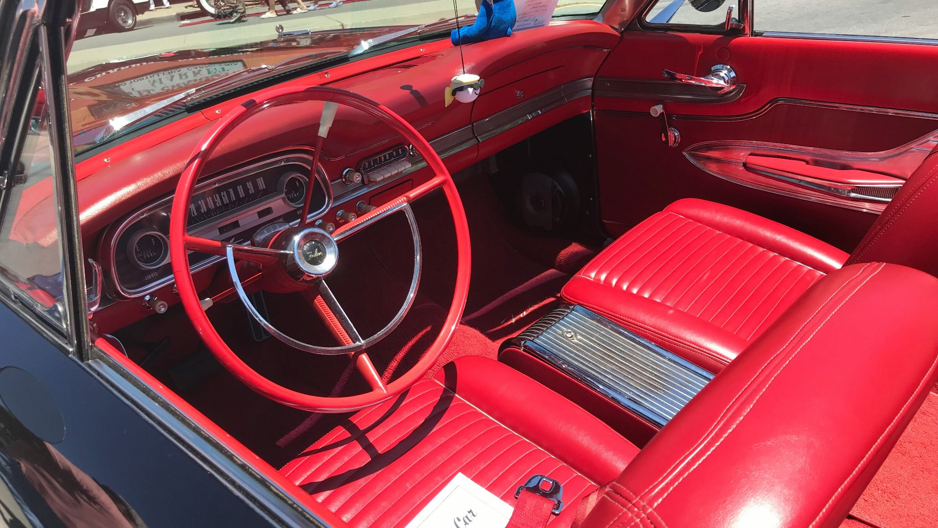 a red car with a steering wheel and dashboard