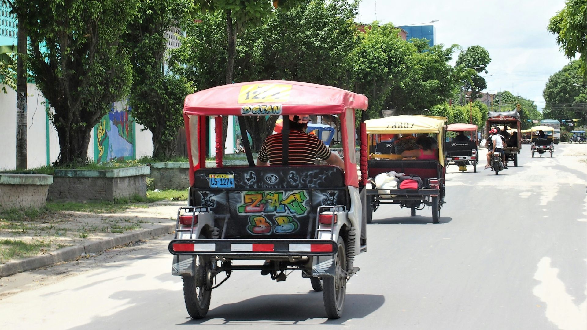 red and black auto rickshaw on road during daytime