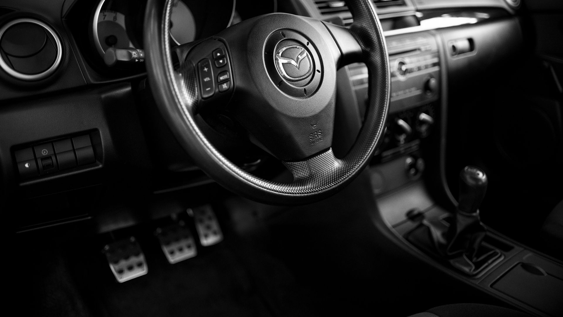 a black and white photo of a car dashboard