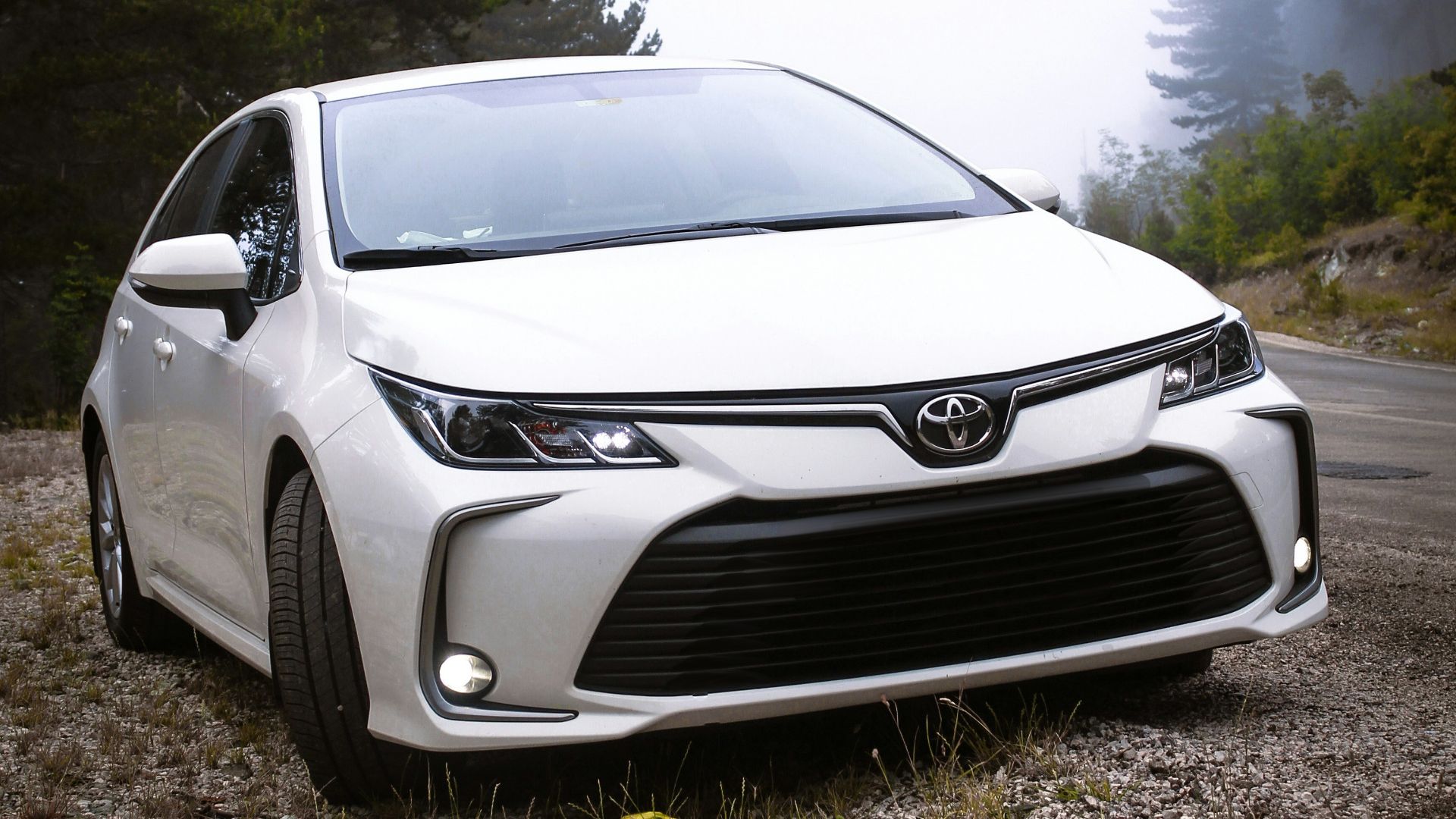 a white car parked on the side of a road