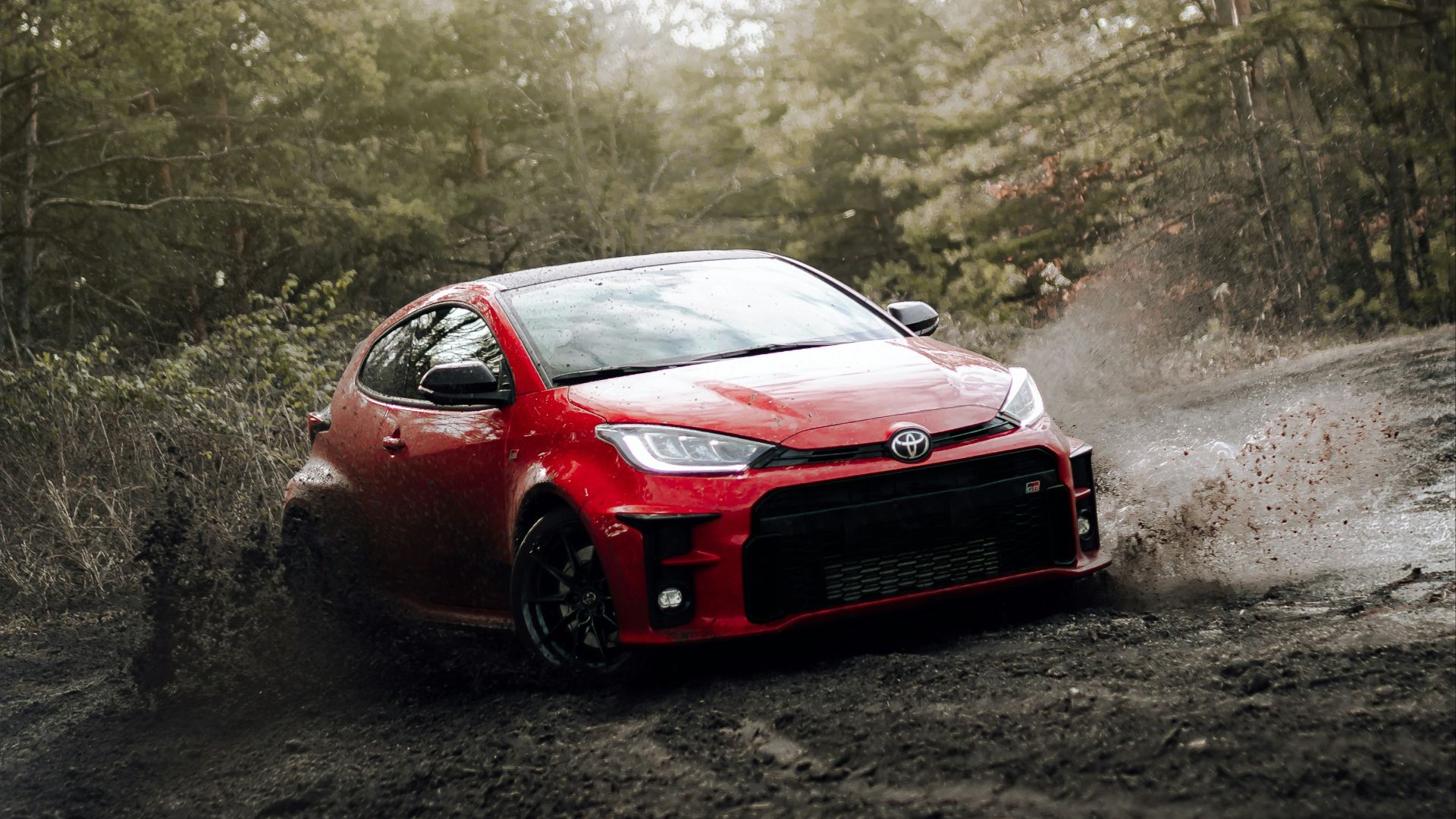 red chevrolet camaro on road