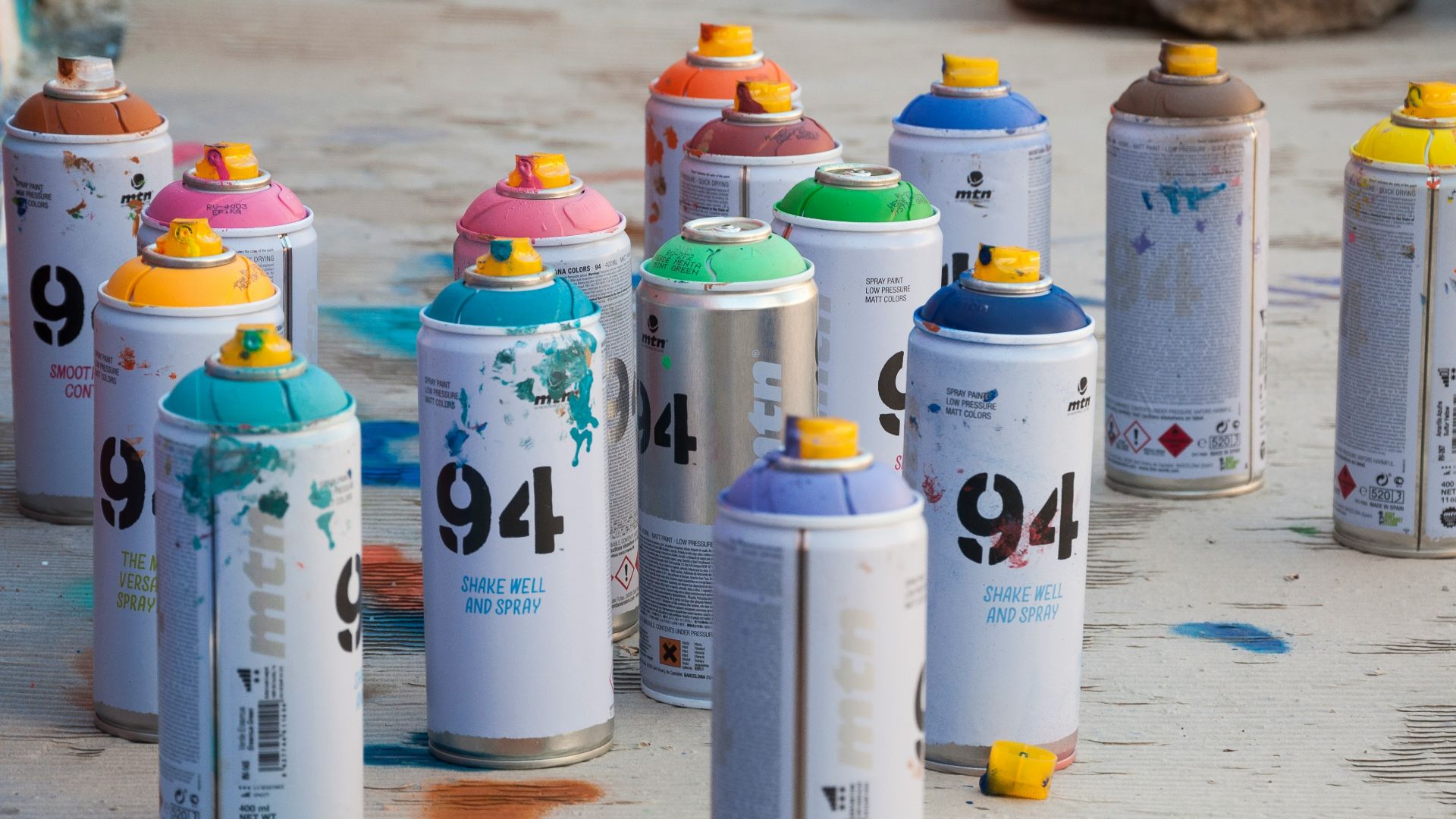 a group of spray paint cans sitting on the ground